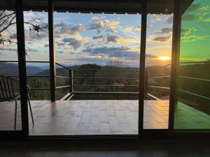 an open door to a balcony with a view of the sunset at Cabañas Ecoturísticas Villa Beatrice in San Francisco +13 photos