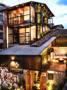 an exterior view of a house with a large building at IG Art in Cusco