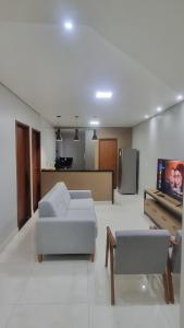 a living room with two couches and a tv at Apartamento completo 2 quartos in Brasília