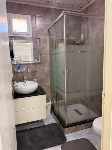 a bathroom with a shower and a sink at Pas de nom in Bouzareah