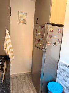 a kitchen with a refrigerator with magnets on it at Pas de nom in Bouzareah