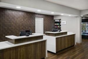 a lobby with two counters with a cash register at Residence Inn by Marriott Flint Grand Blanc in Flint