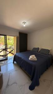 a bedroom with two beds with blue sheets and a window at 204 Eco Paradise Cumbuco in Caucaia