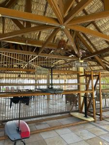 a large straw building with a table and a chair at 204 Eco Paradise Cumbuco in Caucaia