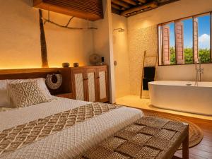 a bedroom with a bed and a tub and a sink at Bali Atins in Atins +102 photos