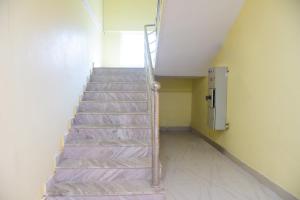 a staircase in a room with a stair case at Hotel Samar Palace Near Sodala Vivek Vihar Metro Station in Jaipur