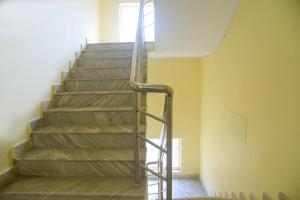 a staircase with a metal handrail in a room at Hotel Samar Palace Near Sodala Vivek Vihar Metro Station in Jaipur