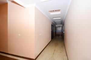 an empty hallway with white walls and a ceiling at Hotel Samar Palace Near Sodala Vivek Vihar Metro Station in Jaipur
