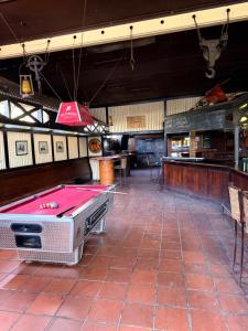 a room with a pool table and a bar at Postmasburg hotel in Postmasburg