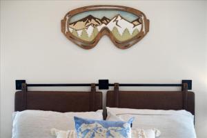 a mirror above a bed with mountains on the wall at Evergreen Retreat Red Lodge in Red Lodge +71 photos