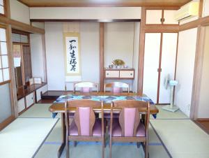 a dining room with a table and chairs at ただいまtadaima in Yahata