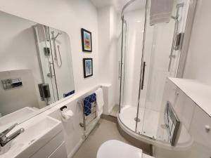 a bathroom with a shower and a toilet and a sink at U Boutique Hotel, SureStay Collection by BW in Wellington +48 photos