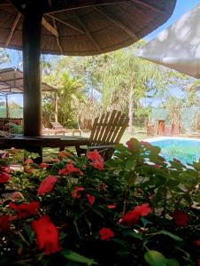 a patio with a table and chairs and flowers at Cabaña La Churra in Corrientes