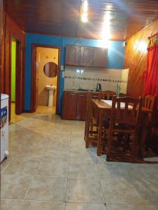 a kitchen with a table and chairs in a room at Cabaña La Churra in Corrientes