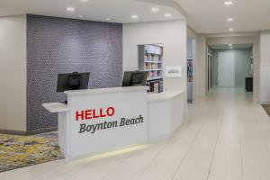 a lobby of a hospital with a hello reception bench at TownePlace Suites by Marriott Boynton Beach in Boynton Beach +38 photos
