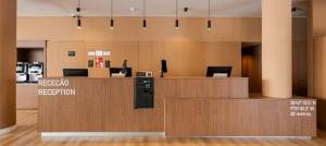 an office lobby with a reception desk and a reception counter at B&B HOTEL Lisboa Aeroporto in Lisbon
