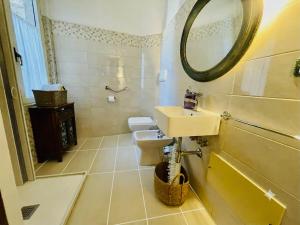 a bathroom with a sink and a mirror at DomoMea Rooms in Loculi