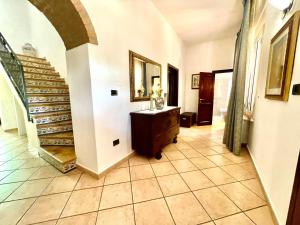a hallway with a staircase in a house at DomoMea Rooms in Loculi