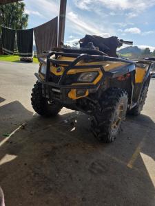a yellow atv parked in a parking lot at Parikino School 