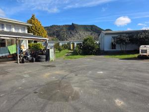 a parking lot in front of a house with a motorcycle at Parikino School 