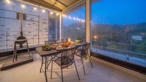 a table with food on it in a room with a window at Gapyeong Ddel Poolvilla in Gapyeong