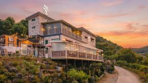 a house on the side of a mountain at Gapyeong Ddel Poolvilla in Gapyeong