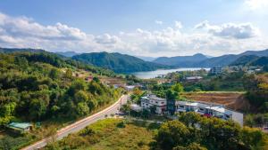 an aerial view of a town with a river and mountains at Gapyeong Ddel Poolvilla in Gapyeong