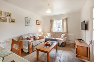 a living room with a couch and a table at 2 Bed in Warminster oc-52105 in West Knoyle