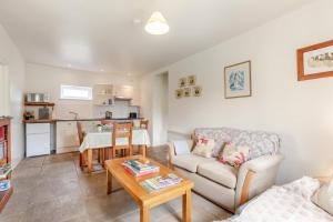 a living room with a couch and a table at 2 Bed in Warminster oc-52105 in West Knoyle