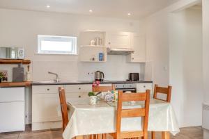 a kitchen with a table and chairs in a kitchen at 2 Bed in Warminster oc-52105 in West Knoyle +12 photos