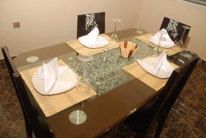 a table with two chairs and a napkin on it at Crispan Luxury Apartment in Jos