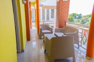 a room with chairs and a balcony at La Reserve Hotel in Cap-Haïtien
