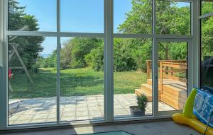 a view of a screened in porch from a window at Lovely Home In Ebeltoft With Sauna in Ebeltoft +25 photos