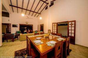 a dining room with a table and a living room at serendipty lake villa in Panadura