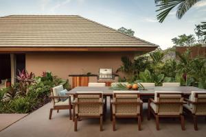 an outdoor dining area with a table and chairs at One&Only Mandarina in Lo de Marcos