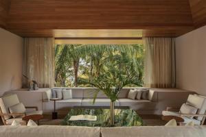 a living room with a couch and a table at One&Only Mandarina in Lo de Marcos +285 photos