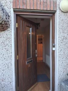 a wooden door leading to a hallway in a building at 2 bedroom house 