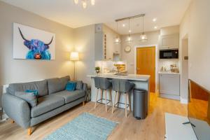 a living room with a couch and a kitchen at 1 Bed in Grasmere oc-lr068 in Grasmere