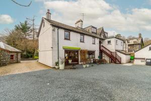 a large white building with a patio in front of it at 1 Bed in Grasmere oc-lr068 in Grasmere