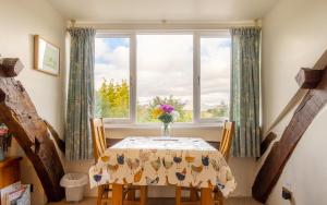 a dining room with a table and a window at 1 Bed in Hawkshead oc-lr072 in Hawkshead +2 photos