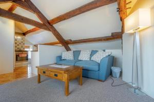 a living room with a blue couch and a table at 1 Bed in Hawkshead oc-lr072 in Hawkshead