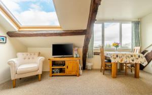 a living room with a tv and a table and chairs at 1 Bed in Hawkshead oc-lr072 in Hawkshead