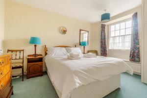 a bedroom with a large white bed and a window at 4 Bed in Ambleside oc-lr082 in Ambleside