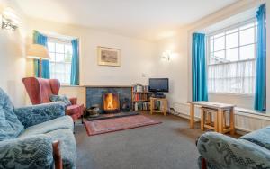 a living room with a couch and a fire place at 4 Bed in Ambleside oc-lr082 in Ambleside