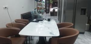 a white table with chairs and a laptop on it at U-ViVu Homestay Ocean Park 3 Hưng Yên in Ðình Loan