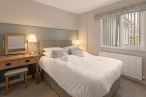 a bedroom with a white bed and a television at 4 Bed in Ambleside oc-lr120 in Ambleside
