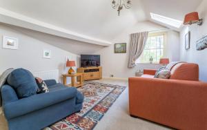 a living room with two couches and a tv at 1 Bed in Grasmere oc-lr124 in Grasmere