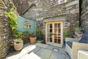 a stone building with a door and some plants at 1 Bed in Grasmere oc-lr124 in Grasmere