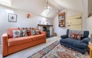 a living room with a couch and a chair at 1 Bed in Grasmere oc-lr124 in Grasmere