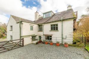 a white house with potted plants in front of it at 5 Bed in Hawkshead oc-lr134 in Hawkshead